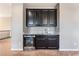 Upper-level wet bar with granite countertop, dark cabinetry, and stainless steel beverage cooler at , Las Vegas, NV 89149