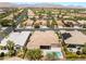 Expansive aerial view of homes featuring desert landscaping, mountain views and a swimming pool at 10331 Rio De Thule Ln, Las Vegas, NV 89135