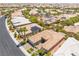 An aerial view of homes with desert landscaping, palm trees and manicured yards at 10331 Rio De Thule Ln, Las Vegas, NV 89135