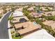 An aerial view of homes with desert landscaping, palm trees and a swimming pool and mountain views at 10331 Rio De Thule Ln, Las Vegas, NV 89135