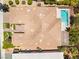 An aerial view of a home with desert landscaping, a manicured yard, a swimming pool, and a tile roof at 10331 Rio De Thule Ln, Las Vegas, NV 89135