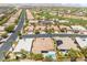 Expansive aerial view of homes featuring desert landscaping, mountain views and a swimming pool at 10331 Rio De Thule Ln, Las Vegas, NV 89135