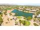Scenic aerial view showcasing the lush golf course and tranquil pond, lined with palm trees and luxury homes at 10331 Rio De Thule Ln, Las Vegas, NV 89135