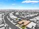 Stunning aerial view of a single story house amid a desert landscape and city skyline in the background at 10331 Rio De Thule Ln, Las Vegas, NV 89135