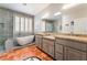 Luxurious bathroom with standalone tub, a walk-in shower, and double vanity with granite counters at 10331 Rio De Thule Ln, Las Vegas, NV 89135