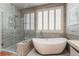 Spa-like bathroom features a soaking tub, glass enclosed shower, and plantation shutters at 10331 Rio De Thule Ln, Las Vegas, NV 89135