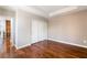 Empty bedroom features hardwood floors, neutral paint, and a closet with mirrored sliding doors at 10331 Rio De Thule Ln, Las Vegas, NV 89135