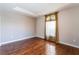 Bedroom boasts hardwood floors, neutral paint, and a window with sheer curtains at 10331 Rio De Thule Ln, Las Vegas, NV 89135