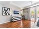 Comfortable bedroom features wood floors, white trim, and double doors to the back patio at 10331 Rio De Thule Ln, Las Vegas, NV 89135