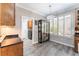 This home features a naturally lit dining area with wood floors, modern lighting, and views of the backyard at 10331 Rio De Thule Ln, Las Vegas, NV 89135