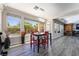 Dining area with gray wood flooring, large windows with backyard views including a pool at 10331 Rio De Thule Ln, Las Vegas, NV 89135