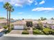 Inviting single-story home with lush front lawn, paver driveway, and blooming landscape at 10331 Rio De Thule Ln, Las Vegas, NV 89135