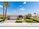 Inviting single story home with a well-manicured lawn and brick driveway under a bright blue sky at 10331 Rio De Thule Ln, Las Vegas, NV 89135