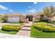 Inviting single story home with manicured lawn and beautiful brick pathway leading to front door at 10331 Rio De Thule Ln, Las Vegas, NV 89135