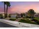 Charming single story home with manicured lawn and palm trees against a colorful sunset sky at 10331 Rio De Thule Ln, Las Vegas, NV 89135