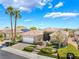 Inviting single-story home with lush front lawn, paver driveway, and blooming landscape at 10331 Rio De Thule Ln, Las Vegas, NV 89135