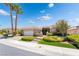 Charming single story home with manicured lawn and palm trees under a bright blue sky at 10331 Rio De Thule Ln, Las Vegas, NV 89135