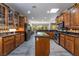 The kitchen features stainless steel appliances, sleek black counters, warm cabinets and a large island at 10331 Rio De Thule Ln, Las Vegas, NV 89135