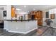 Open kitchen with gray wood floors, a skylight, dark countertops, and ample wooden cabinetry at 10331 Rio De Thule Ln, Las Vegas, NV 89135