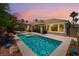 Relaxing pool with lounge area and palm trees under a colorful evening sky at 10331 Rio De Thule Ln, Las Vegas, NV 89135