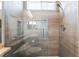 Walk-in shower features glass enclosure, tiled walls and bench, and rain shower head at 10331 Rio De Thule Ln, Las Vegas, NV 89135