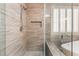 Tiled walk-in shower with seat features a niche for toiletries and a glass enclosure at 10331 Rio De Thule Ln, Las Vegas, NV 89135