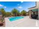 Stunning backyard pool featuring a baja shelf, desert landscaping, and an outdoor grill at 10331 Rio De Thule Ln, Las Vegas, NV 89135