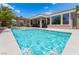 Inviting backyard pool featuring baja shelf, desert landscaping, a covered patio, and well manicured yard at 10331 Rio De Thule Ln, Las Vegas, NV 89135