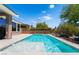 Resort style backyard pool with a baja shelf, desert landscaping, and a beautifully landscaped yard at 10331 Rio De Thule Ln, Las Vegas, NV 89135