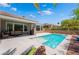 Beautiful backyard pool with lounge seating, patio, clear blue water, and views of the landscaped backyard at 10331 Rio De Thule Ln, Las Vegas, NV 89135