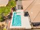 An aerial view shows a pristine swimming pool with a patio and manicured landscaping at 10331 Rio De Thule Ln, Las Vegas, NV 89135