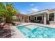 Relaxing backyard pool featuring baja shelf, desert landscaping, a covered patio, and an outdoor seating area at 10331 Rio De Thule Ln, Las Vegas, NV 89135