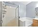 Clean bathroom showcasing glass-enclosed shower and separate white tiled tub at 109 Breezy Tree Ct # 202, Las Vegas, NV 89145