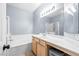 Bright bathroom features shower-over-tub with vanity and a full-width mirror at 109 Breezy Tree Ct # 202, Las Vegas, NV 89145