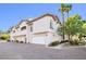 Exterior view of a townhome featuring a brick driveway, garage and lush landscaping at 109 Breezy Tree Ct # 202, Las Vegas, NV 89145
