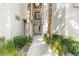 Pathway to a well-maintained condo entrance, with mature landscaping at 109 Breezy Tree Ct # 202, Las Vegas, NV 89145