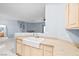 Bright kitchen featuring a large farmhouse sink, neutral countertops, and modern faucet with tile flooring at 109 Breezy Tree Ct # 202, Las Vegas, NV 89145