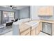 This kitchen features a farmhouse sink, modern faucet, and stainless steel dishwasher with an open living space at 109 Breezy Tree Ct # 202, Las Vegas, NV 89145