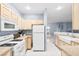 Bright kitchen with gas range, white appliances, light cabinets, and tile floors at 109 Breezy Tree Ct # 202, Las Vegas, NV 89145