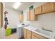 Functional laundry room featuring a sink, cabinets, washer, and dryer at 109 Breezy Tree Ct # 202, Las Vegas, NV 89145