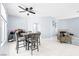 Open-concept living space with dining table and chairs, fireplace, and neutral decor at 109 Breezy Tree Ct # 202, Las Vegas, NV 89145