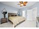 Serene primary bedroom featuring tile floors, a ceiling fan, and tasteful decor with two door access points at 109 Breezy Tree Ct # 202, Las Vegas, NV 89145