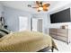 Comfortable main bedroom with ceiling fan, TV, dresser and ensuite bathroom at 109 Breezy Tree Ct # 202, Las Vegas, NV 89145
