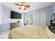 Comfortable main bedroom with ceiling fan, TV, dresser and natural light at 109 Breezy Tree Ct # 202, Las Vegas, NV 89145