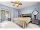 Cozy main bedroom with tile flooring, a leaf ceiling fan, a private patio entrance, and stylish decor at 109 Breezy Tree Ct # 202, Las Vegas, NV 89145