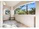 This patio features an arching wall with views of surrounding greenery and a solitary bench at 109 Breezy Tree Ct # 202, Las Vegas, NV 89145