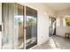 Exterior patio view showing a sliding glass door that allows natural light, and arching walls with greenery views at 109 Breezy Tree Ct # 202, Las Vegas, NV 89145