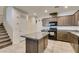 Open kitchen with granite countertops, tile flooring, and stainless steel appliances at 1200 Mission View Ct, Henderson, NV 89002