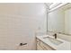 Bathroom with white tile and vanity featuring granite countertop at 1201 Bourbon St, Pahrump, NV 89048