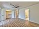 Spacious bedroom featuring wood-look flooring, ceiling fan, and ensuite bathroom at 1201 Bourbon St, Pahrump, NV 89048